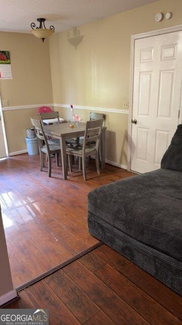 dining room with baseboards and hardwood / wood-style floors