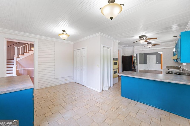 209 Westminster Hwy, Westminster, SC 29693 - kitchen with black fridge, a ceiling fan, blue cabinetry, double oven, and light stone finish flooring