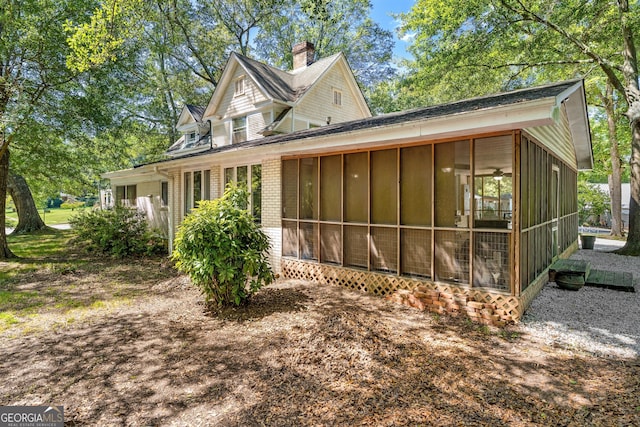 209 Westminster Hwy, Westminster, SC 29693 - view of home's exterior with a sunroom, brick siding, and a chimney
