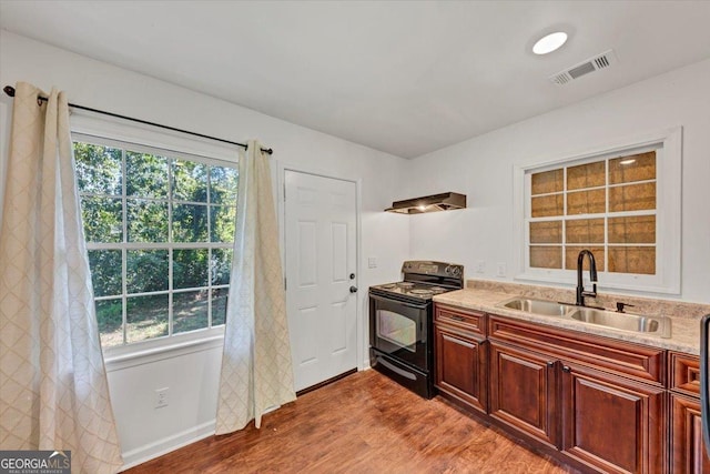 856 Glenway Dr, East Point, GA 30344 - kitchen featuring ventilation hood, visible vents, wood finished floors, a sink, and black range with electric stovetop
