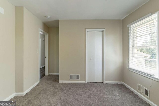 2062 Whites Mill Rd, Decatur, GA 30032 - unfurnished bedroom featuring baseboards, visible vents, and carpet floors