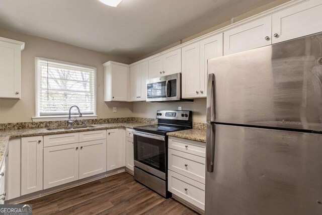 2062 Whites Mill Rd, Decatur, GA 30032 - kitchen with dark wood finished floors, white cabinetry, light stone counters, a sink, and stainless steel appliances