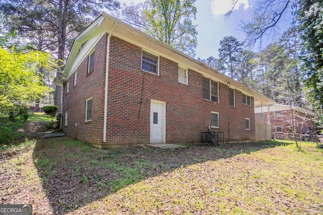 back of house featuring brick siding