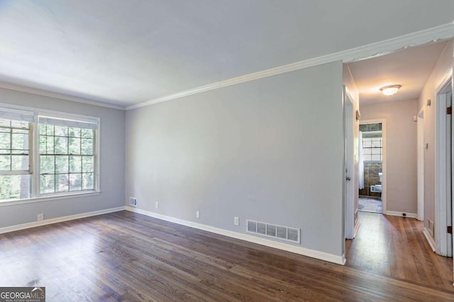 unfurnished room with visible vents, baseboards, and dark wood-style floors