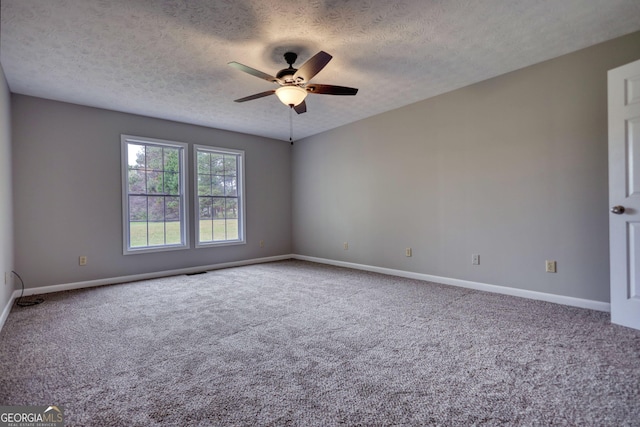 spare room featuring carpet, baseboards, a textured ceiling, and ceiling fan