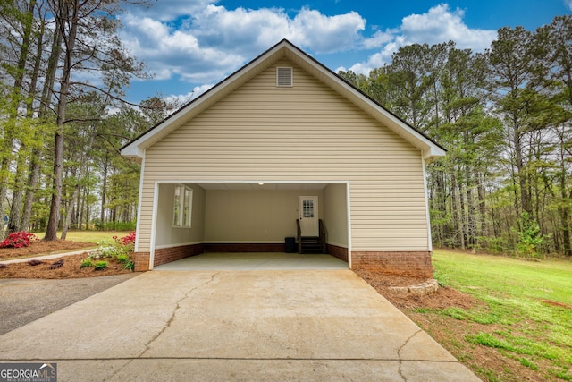 view of side of home featuring entry steps, driveway, and a lawn