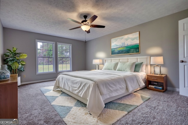 bedroom featuring baseboards, carpet, and a textured ceiling