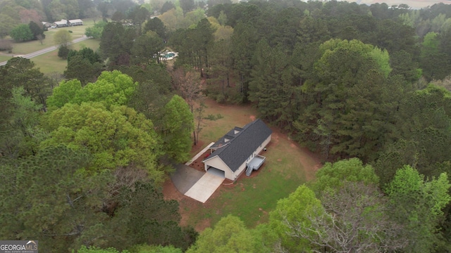 drone / aerial view featuring a view of trees