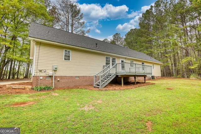 rear view of house with a lawn, stairway, crawl space, a wooden deck, and a shingled roof