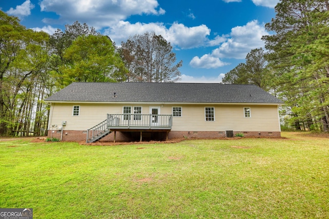 back of property with roof with shingles, stairway, crawl space, a deck, and a lawn
