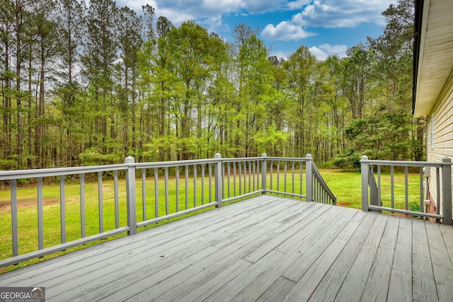 wooden deck with a lawn