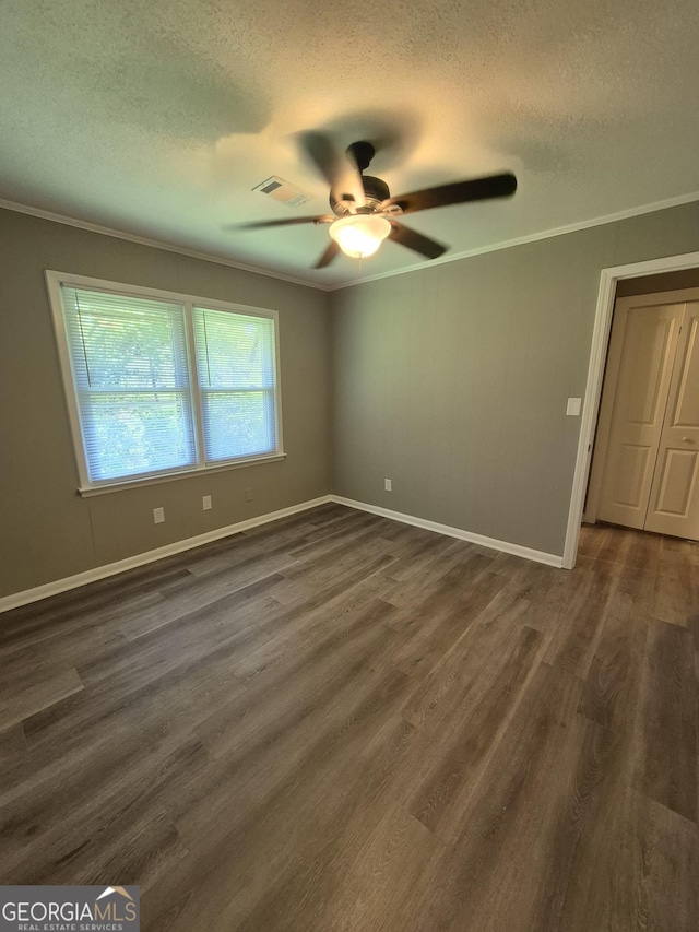 unfurnished room with crown molding, visible vents, a ceiling fan, and a textured ceiling
