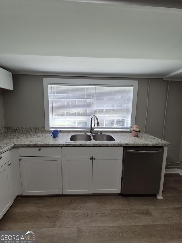 kitchen featuring white cabinets, dishwasher, a sink, wood finished floors, and light stone counters