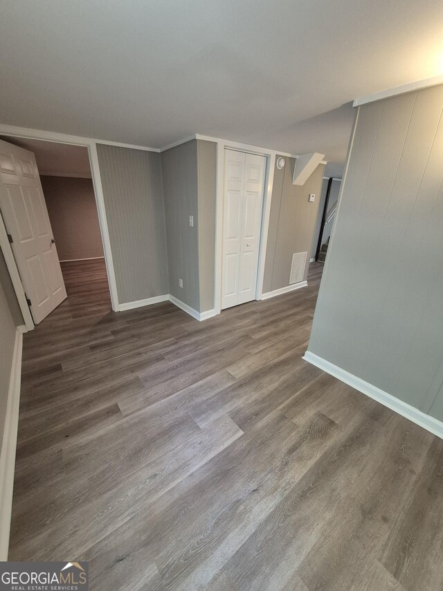interior space featuring visible vents, baseboards, and wood finished floors