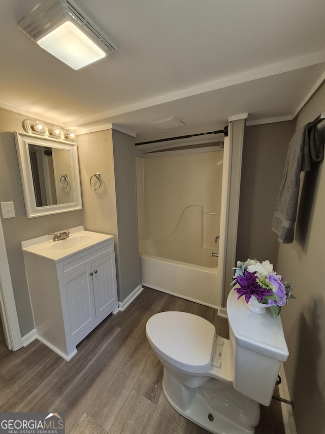 bathroom with vanity, baseboards, toilet, shower / bathing tub combination, and wood finished floors