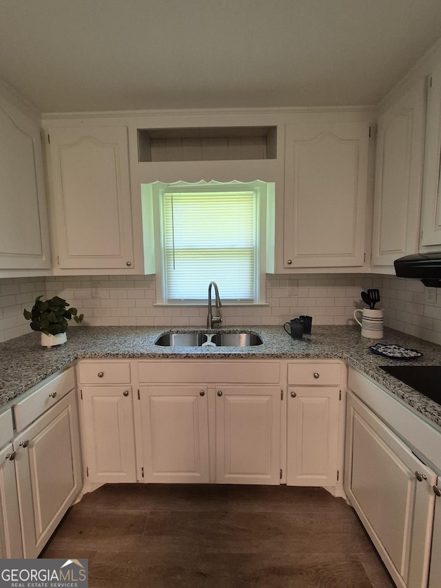 kitchen with white cabinetry and a sink