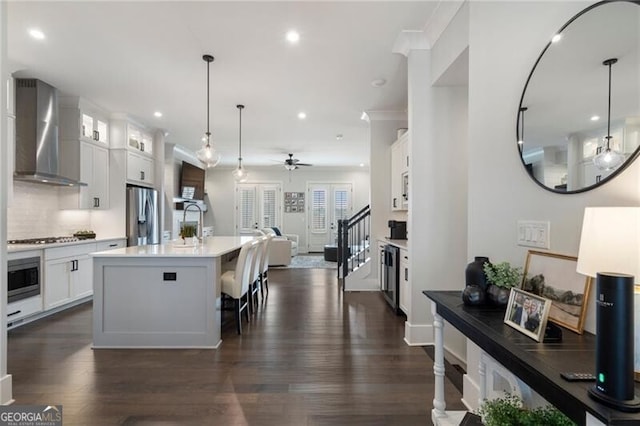 825 Maplewood Dr, Roswell, GA 30075 - kitchen with stainless steel fridge with ice dispenser, wall chimney range hood, open floor plan, ceiling fan, and wall oven