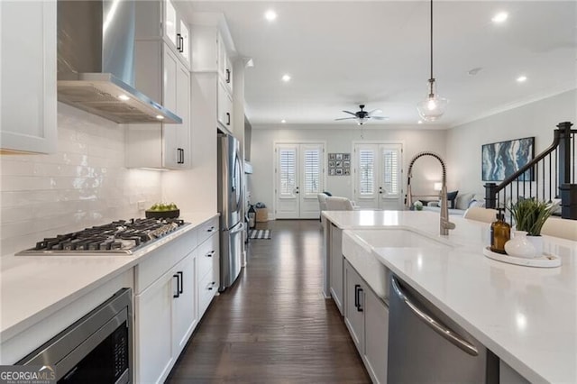 825 Maplewood Dr, Roswell, GA 30075 - kitchen featuring a sink, open floor plan, wall chimney exhaust hood, and stainless steel appliances