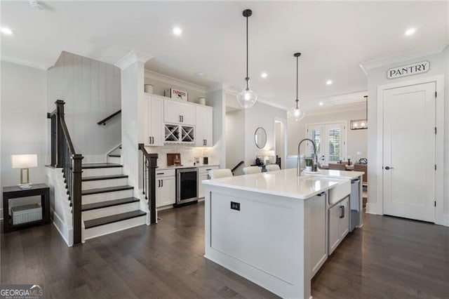 825 Maplewood Dr, Roswell, GA 30075 - kitchen featuring dark wood-style floors, beverage cooler, and light countertops