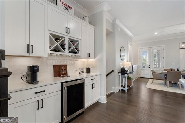 825 Maplewood Dr, Roswell, GA 30075 - bar featuring ornamental molding, backsplash, a dry bar, dark wood finished floors, and beverage cooler