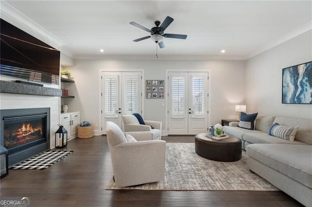 825 Maplewood Dr, Roswell, GA 30075 - living area with dark wood-style floors, a large fireplace, and crown molding