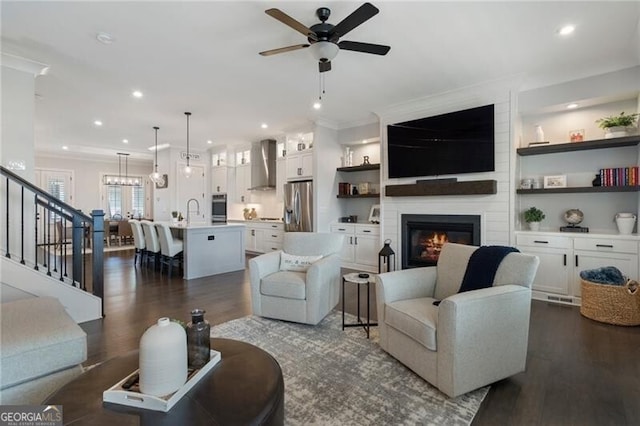825 Maplewood Dr, Roswell, GA 30075 - living room featuring ornamental molding, a fireplace, stairs, dark wood finished floors, and ceiling fan