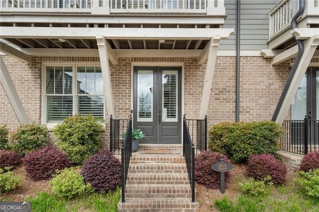 825 Maplewood Dr, Roswell, GA 30075 - entrance to property with brick siding, french doors, and a balcony