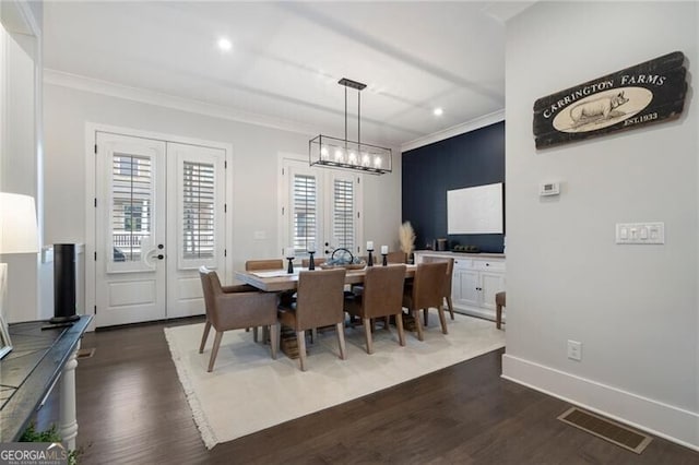 825 Maplewood Dr, Roswell, GA 30075 - dining space featuring dark wood-style floors, french doors, ornamental molding, and visible vents
