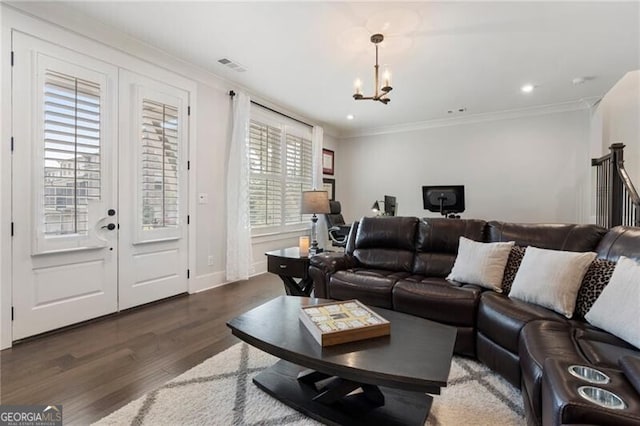 825 Maplewood Dr, Roswell, GA 30075 - living area featuring ornamental molding, visible vents, an inviting chandelier, and wood finished floors