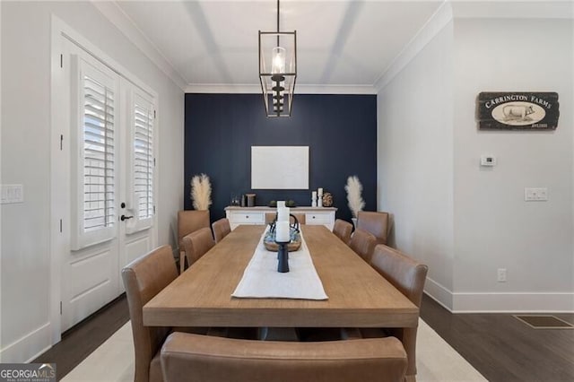 825 Maplewood Dr, Roswell, GA 30075 - dining room with an accent wall, baseboards, ornamental molding, and wood finished floors