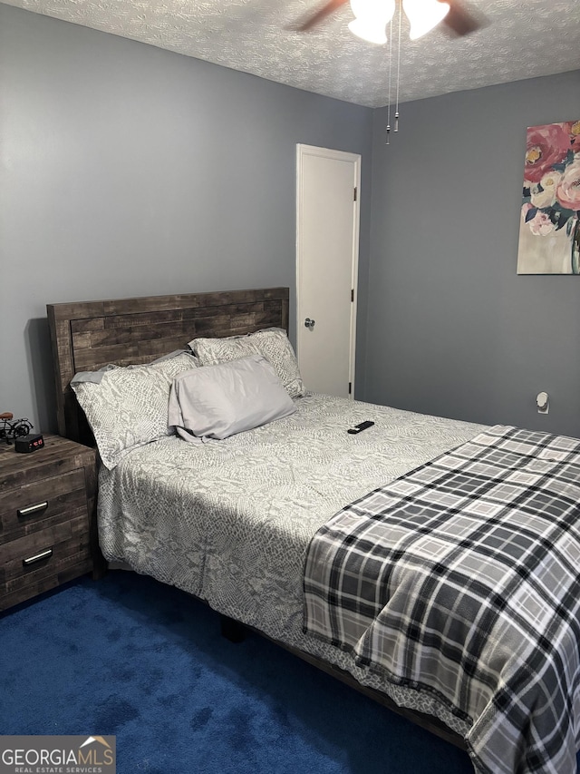 bedroom with carpet, a textured ceiling, and ceiling fan