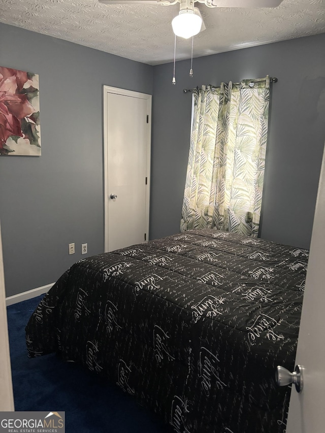 bedroom with carpet flooring and a textured ceiling