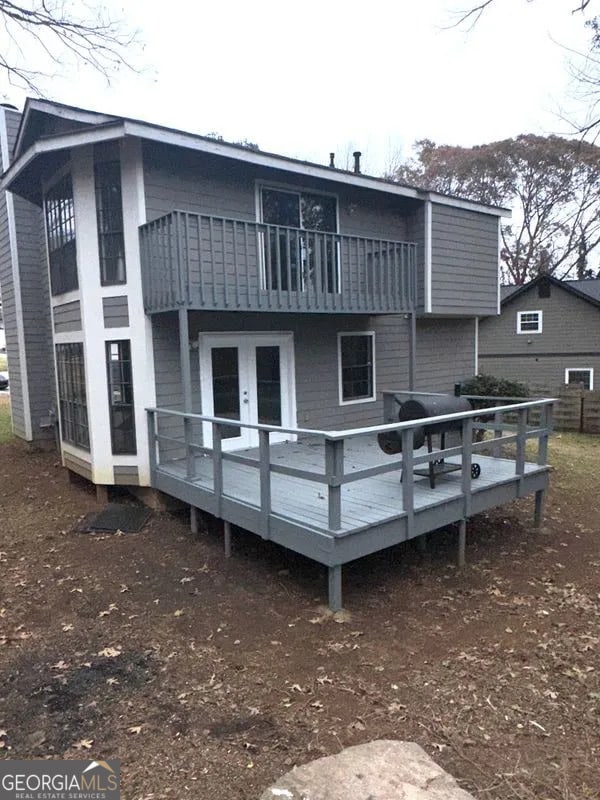 rear view of property featuring a balcony