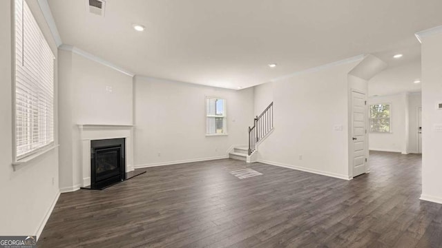 1139 Blue Juniper Cir, Loganville, GA 30052 - unfurnished living room featuring ornamental molding, dark wood finished floors, stairs, visible vents, and a healthy amount of sunlight