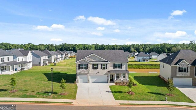 1139 Blue Juniper Cir, Loganville, GA 30052 - view of front of home featuring driveway, a residential view, a garage, and a front lawn