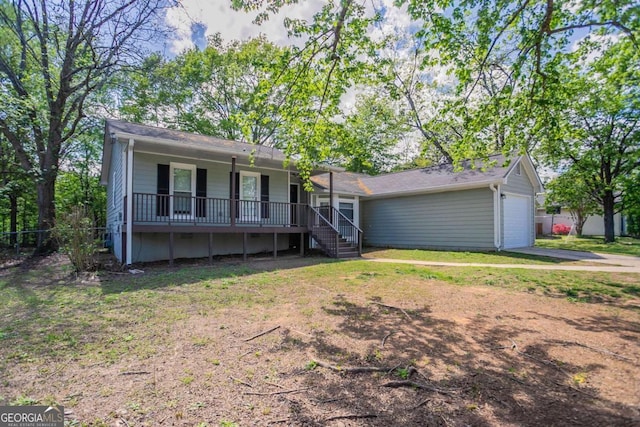 ranch-style house featuring a front yard, driveway, and an attached garage