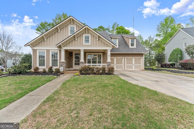 6058 Grand Reunion Dr, Hoschton, GA 30548 - craftsman-style home with board and batten siding, a front lawn, covered porch, and driveway