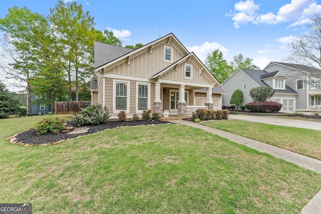6058 Grand Reunion Dr, Hoschton, GA 30548 - craftsman house with board and batten siding, a porch, a front yard, fence, and driveway