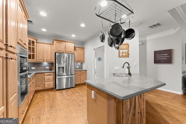 6058 Grand Reunion Dr, Hoschton, GA 30548 - kitchen featuring crown molding, light wood-style floors, visible vents, a sink, and stainless steel appliances