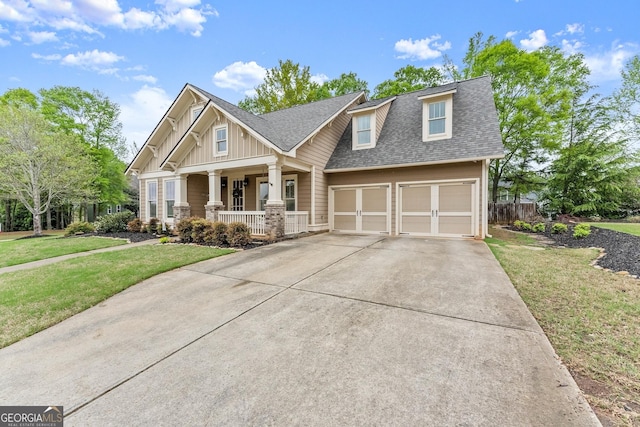 6058 Grand Reunion Dr, Hoschton, GA 30548 - craftsman-style home with a garage, a porch, a front yard, a shingled roof, and driveway