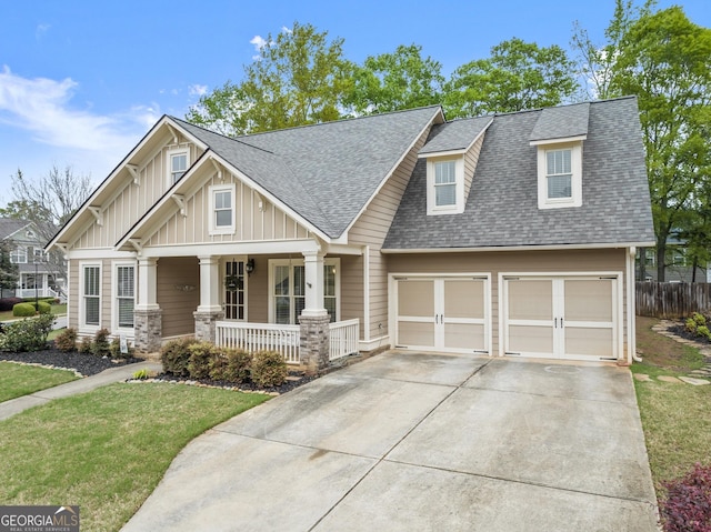 6058 Grand Reunion Dr, Hoschton, GA 30548 - craftsman inspired home with driveway, board and batten siding, a front yard, a porch, and a shingled roof