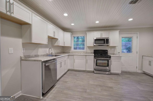 3647 Miller St, Lithia Springs, GA 30122 - kitchen with appliances with stainless steel finishes, a sink, crown molding, recessed lighting, and white cabinetry
