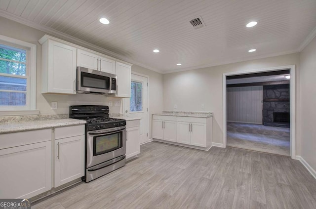3647 Miller St, Lithia Springs, GA 30122 - kitchen featuring stainless steel appliances, ornamental molding, a fireplace, white cabinets, and recessed lighting