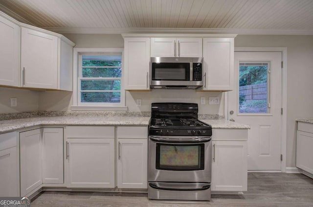 3647 Miller St, Lithia Springs, GA 30122 - kitchen featuring stainless steel appliances, crown molding, healthy amount of natural light, white cabinets, and wooden ceiling