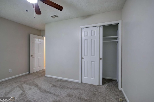 3647 Miller St, Lithia Springs, GA 30122 - unfurnished bedroom featuring carpet, a closet, baseboards, a textured ceiling, and a ceiling fan