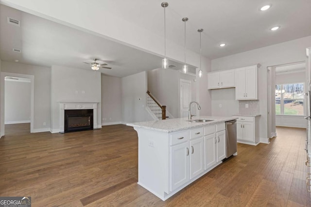 kitchen with a ceiling fan, white cabinets, visible vents, a sink, and dark wood-style floors