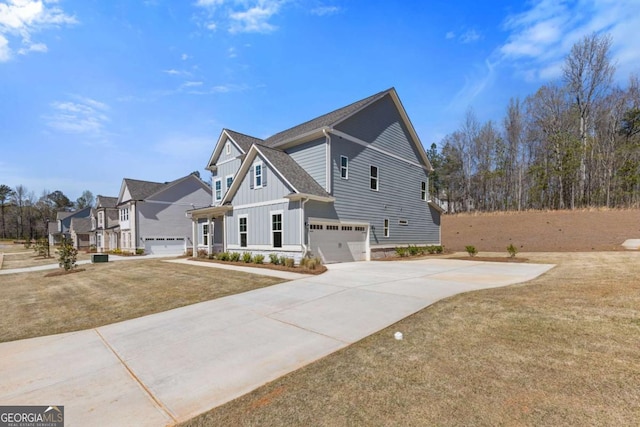 view of side of property with concrete driveway, a lawn, board and batten siding, a garage, and a shingled roof