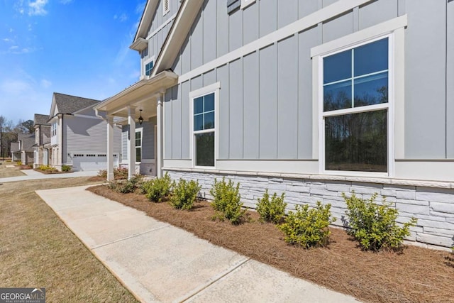 view of side of property featuring board and batten siding and a residential view