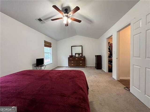 carpeted bedroom featuring visible vents, baseboards, ceiling fan, and lofted ceiling