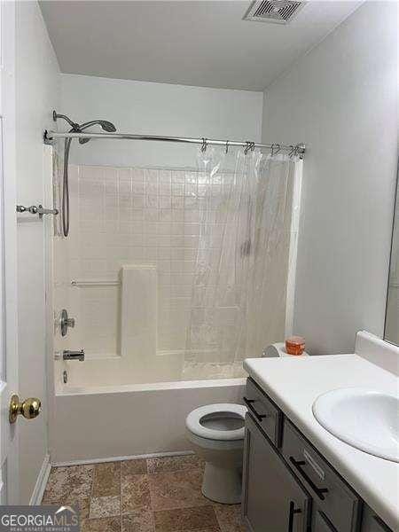 bathroom with toilet, vanity, shower / bathing tub combination, and visible vents